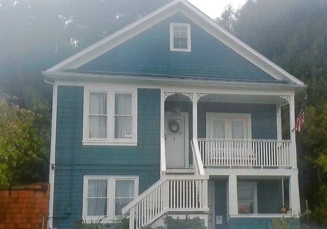 Front view of two story residence with apartment at grade and stairs to owner apartment above.